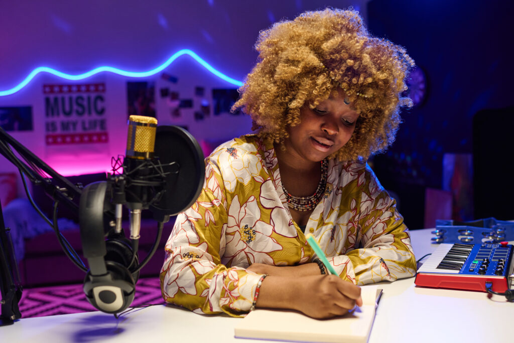 Young Woman Writing Song At Studio